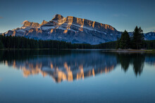 Rundle Mountain Reflecting In Two Jack Lake In Banff National Park At Sunrise.