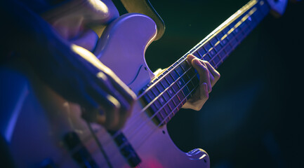 Wall Mural - Close-up of a man playing the bass guitar.