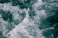 Sea Foam Of The Waves Crushing Into The Shore Texture. Wild Powerful Waves Are Splashing And Forming Foam