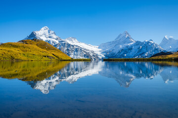 Wall Mural - bachalpsee, grindelwald, switzerland. high mountains and reflection on the surface of the lake.