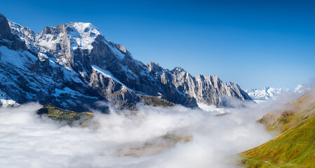 Poster - Grindelwald, Switzerland. Mountains and clouds in the valley. Natural landscape high in the mountains.