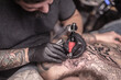 © Mr. Prof - Tattooer makes tattoo in salon