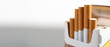 Open pack of cigarettes with several stretched cigarettes close-up