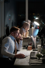 Aufkleber - Young elegant male economist looking at computer screen while sitting by desk in office against Muslim female colleague