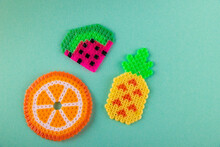 Toy Plastic Flat Fruits. Orange, Watermelon, Pineapple Lay On Blue Background