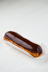 Wall Mural - chocolate eclair, Traditional french dessert eclair with custard and chocolate icing