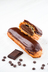 Canvas Print - chocolate eclair, Traditional french dessert eclair with custard and chocolate icing