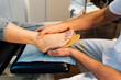 © Henko Studio - Chiropodist fitting an orthopedic foot insole to a patient.