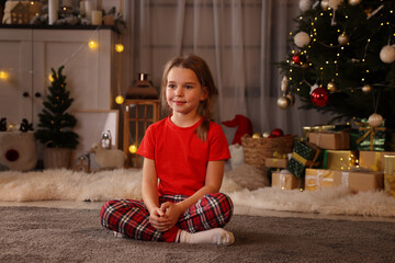 Wall Mural - Cute little child in room with Christmas tree