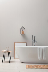 Canvas Print - Modern ceramic bathtub near light wall indoors