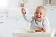 © New Africa - Cute little baby eating healthy food at home. Space for text