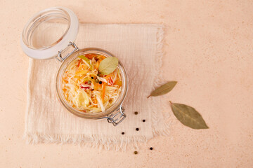 Wall Mural - Homemade sauerkraut. Fermented cabbage in a jar on a linen napkin. Vegan food. Top view.