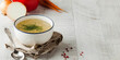  Healthy bone broth in a bowl with dill on a light wooden background. Copy space