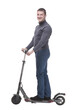 © ASDF - in full growth. casual young man with an electric scooter.