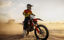 Motocross Rider On Sportmotor Over Dust Landscape
