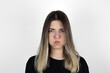 © burhan - Close up photo of bored girl. She is blowing her cheek against white background. White background. Mouth inflated with air, crazy expression.