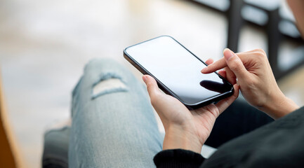 Wall Mural - closeup young woman using smartphone. woman hand touch screen smartphone in hand, online message.