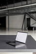 © Westend61 - Laptop with blank screen on desk at industial hall