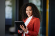 © Westend61 - Happy businesswoman working on digital tablet in office