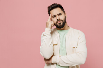 Sticker - Young sad pensive thoughtful minded caucasian man 20s in trendy jacket shirt prop up head look camera forehead isolated on plain pastel light pink background studio portrait. People lifestyle concept.