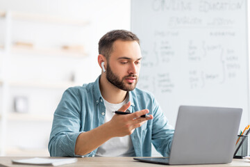 Poster - Learning English online. Focused male teacher giving foreign language lesson on web using laptop