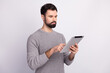 © Tetiana - Profile side photo of young business man typing letter tablet prepresentative presentation isolated over grey color background