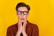© Tetiana - Photo of young guy hands touch cheeks tired look empty space eyewear isolated over yellow color background