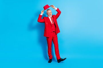 Sticker - Photo of cheerful positive funny retired man put on hat posing wear red suit shoes isolated blue color background