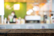© jittawit21 - image of wooden table in front of abstract blurred background