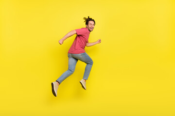 Sticker - Full size profile photo of brunet young guy run wear red t-shirt jeans sneakers isolated on yellow background