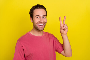 Sticker - Photo of friendly positive guy show v-sign peaceful symbol wear pink t-shirt isolated yellow color background