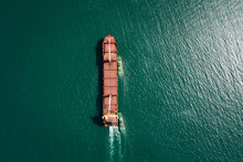 Aerial View Tugboat Pulling Red Oil Ship To Shipyard Dry Dock Repairing And Maintenance In Green Sea