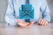 Businessman hand holding letter icon,email icons.Contact us by newsletter email and protect your personal information from spam mail.Customer service call center contact us.Email marketing newsletter.