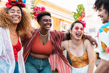 Wall Mural - Carnival day in Brazil, woman and friends dance at street party. People in costumes celebrate Brazilian Carnaval