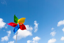 Colorful Pinwheel Blowing In Wind Against Sky