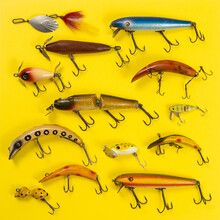 Retro Fishing Lures Against Yellow Background