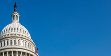 USA, Washington D.C., USA Capital Building With Flag Against Blue Sky