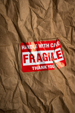 Fragile Handle With Care Sticker On Crushed Package