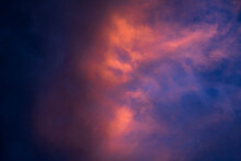 Dramatic Pink Clouds Against Dark Blue Sky