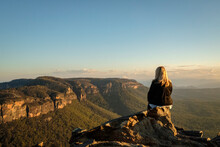 Australia, NSW, Blue Mountains National Park, Rear View Of Woman Looking At View In Megalong Valley At Sunset
