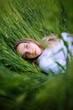 © Tetra Images - Young woman lying in grass