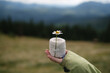 © yarohork - Female hand holding chamomile and bandage at mountains background.