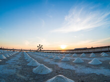 Landscape Summer View Sea Salt Pile Formed  Natural Sea Water In Open Field Known Salt Field Way Along Coastline In Salt Making According Ancient Culture Area Visible Windmills. And Blue Sky In Suns