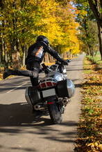 Young Male Motorcycle Getting On A Motorcycle, Rear View, Helmet For Riding A Motorcycle. Safe Motorcycle Ride. Autumn Road And Trees. Minsk Belarus, September, 2021