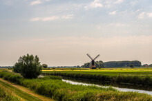 Polder Landscape With The Uitwijkse Molen, A Thatched Hollow Post Mill, Near The Dutch Village Of Sleeuwijk, Province Of North Brabant. The Mill Was Built In The Year 1700 And Is A National Monumenr
