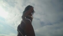 Pretty Ebony Swimsuit Model Walking On The Beach In White Swimsuit