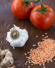 lentils, tomatoes, garlic on vintage tin background