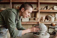 Young Woman Making Human Face From Clay, She Creating Clay Sculptures In The Workshop