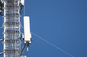 Internet towers and transmission equipment on clean blue sky background