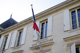 Fototapeta  - sous Préfecture means sub-prefecture in french city with france blue white red flag in town center on outdoor building wall